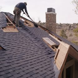 A roofing contractor installing shingles on a house. Featuring s A roofing contractor installing shingles on a house. Featuring s